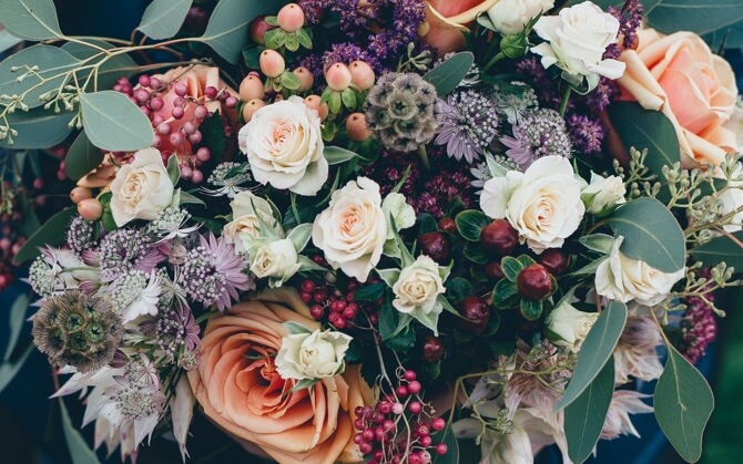 bouquet with pink and white roses as well as some purple flowers